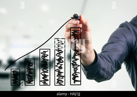 business man drawing a growing graph Stock Photo