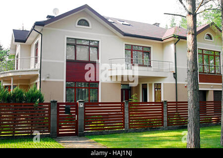 big luxury house with fence and green grass Stock Photo