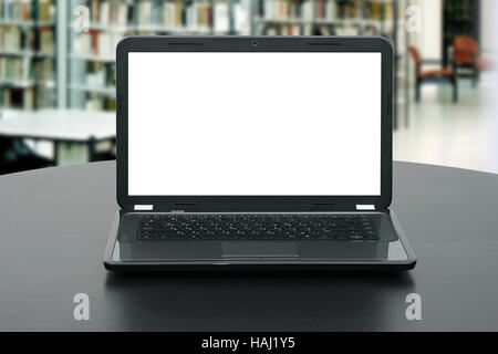 laptop with blank screen on the table in library Stock Photo