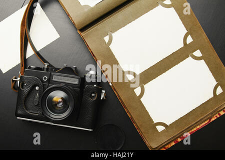 old vintage camera with album and blank pictures Stock Photo