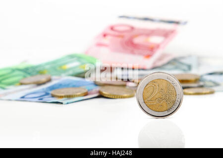 two euro coin with other euro coins and banknotes in background Stock Photo