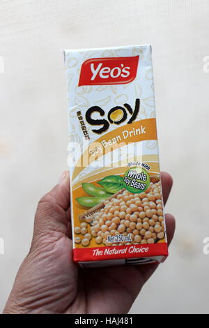 Close up of a child hand holding Yeo's Soy Bean drink Stock Photo