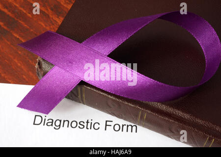 Pancreatic cancer diagnosis.  Awareness purple ribbon on a book. Stock Photo