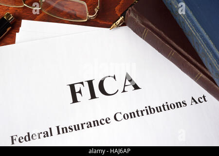 Papers with FICA Federal Insurance Contributions Act tax. Stock Photo