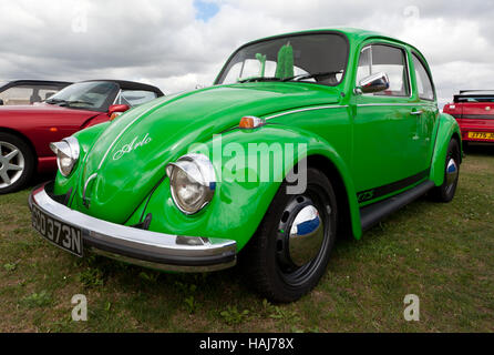 Three-quarter Front view of a green, 1974 Volkswagen Beetle on display in a  Car Club Zone of the 2016 Silverstone Classic Stock Photo