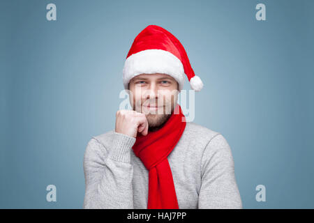 Portrait of a handsome man with beard wearing a Christmas hat Stock Photo
