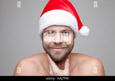 Portrait of a handsome man with beard wearing a Christmas hat Stock Photo