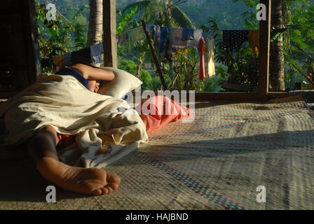 Boy asleep in the jungle, Lawigan, San, Joaquin, Iloilo, Philippines. Stock Photo