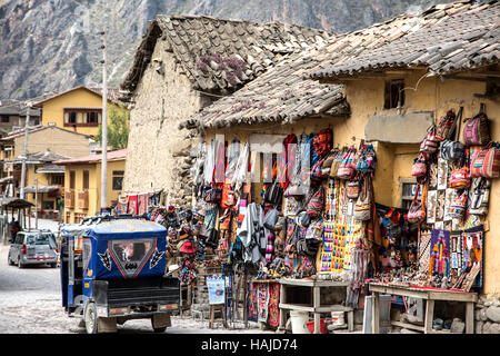 Mototaxi going by vendor stalls and souvenirs, Ollantaytambo, Cusco, Peru Stock Photo