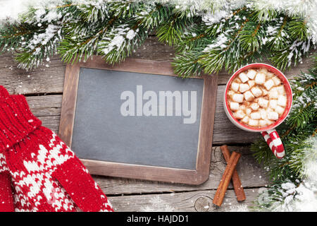 Christmas fir tree, hot chocolate, mittens and chalkboard for your greetings. Top view with copyspace Stock Photo