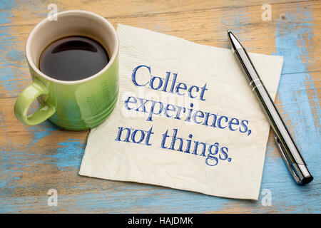 Collect experiences not things - words of inspiration on a napkin with a cup of coffee Stock Photo