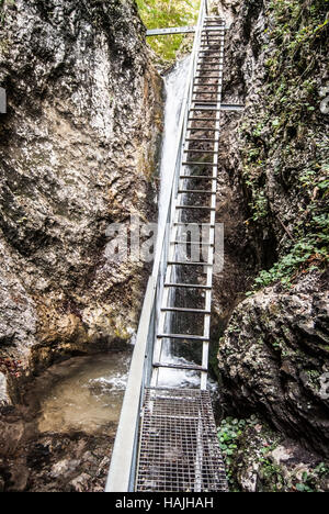 ladder on hiking trail with waterfall and rocks around in Janosikove diery gully in Mala Fatra mountains in Slovakia Stock Photo