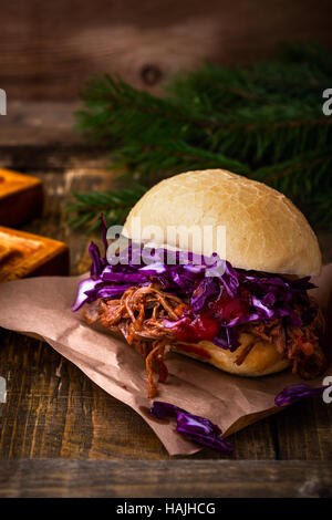 Homemade bbq beef burger with crunchy red cabbage slaw on rustic table. Barbecue meat sandwiches for christmas lunch Stock Photo