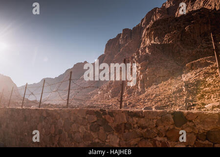 Barbed wire fence in desert Stock Photo
