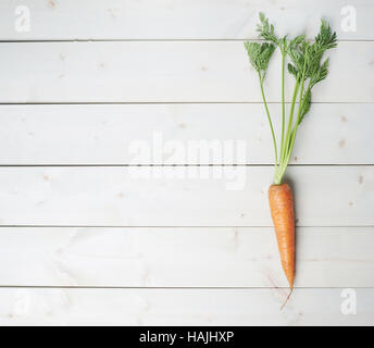 Raw whole carrot on wooden surface table Stock Photo