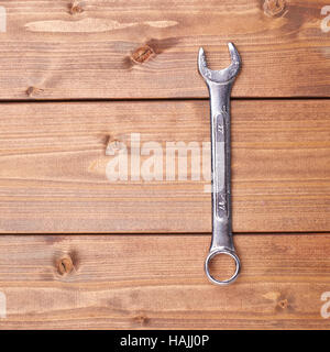 Wrench chrome metal spanner instrument on wooden surface Stock Photo