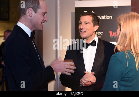 The Duke of Cambridge (left) meets Bear Grylls and Shara Grylls during the Tusk Conservation Awards at the Victoria and Albert Museum in London. Stock Photo