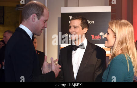 The Duke of Cambridge (left) meets Bear Grylls and Shara Grylls during the Tusk Conservation Awards at the Victoria and Albert Museum in London. Stock Photo