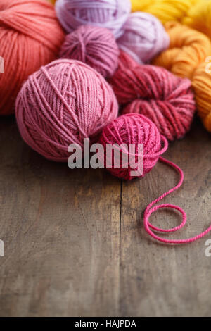 Balls of wool on old wooden background Stock Photo