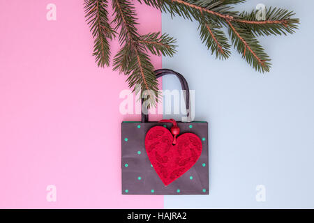 Xmas composition. Shopping bag hanging on the christmas tree twigs as decoration. Shop, sale and gifts concept. Top view. Flat lay Stock Photo