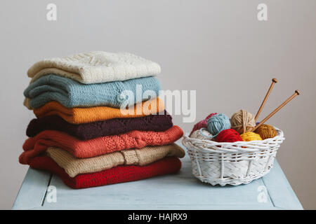 Knitted sweaters with knitting needles and wool Stock Photo