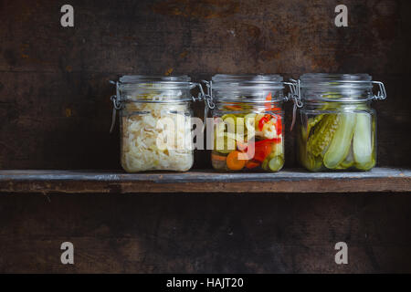 Pickled vegetables in glass jars side by side Stock Photo