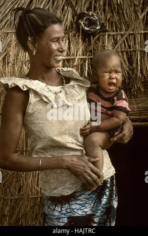 Mali, West Africa - January 25, 1992: Dogon village and typical mud buildings with  barns for cereals and Peul Fulani popolations Stock Photo