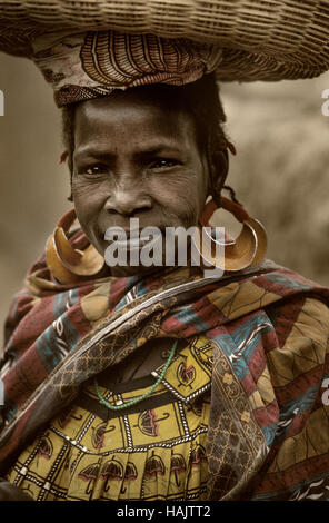 Mali, West Africa - January 25, 1992: Dogon village and typical mud buildings with  barns for cereals and Peul Fulani popolations, portrait of woman,  Stock Photo