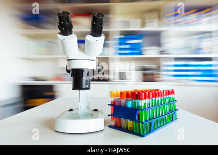Scientific laboratory with microscope and test tubes with samples ...
