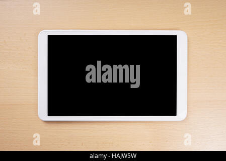 tablet computer with blank display on wooden desk Stock Photo