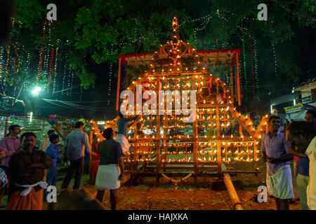 Oil lamps lit on a banyan tree shaped wooden frame in connection with Ezhamkulam temple festival, Kerala, India Stock Photo