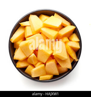 Bowl of pumpkin pieces isolated on white background, top view Stock Photo