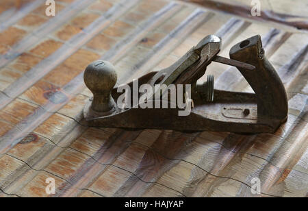 old iron plane on the wooden table Stock Photo