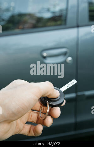hand holding remote control car key Stock Photo