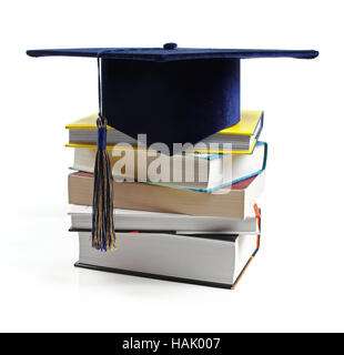 graduation hat and stack of books isolated on white Stock Photo
