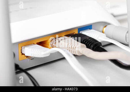 close up of internet wireless router with plugged cables Stock Photo