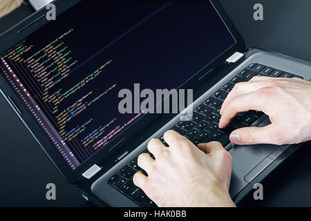 programmer occupation - writing programming code on laptop Stock Photo