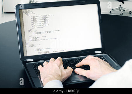 website development process - programmer writing code Stock Photo