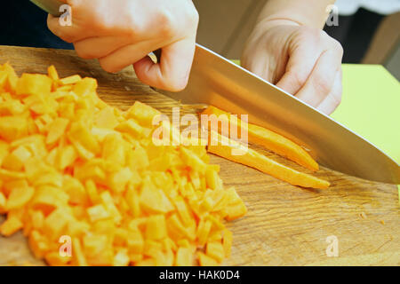 cutting fresh, raw carrot on the cutting board Stock Photo