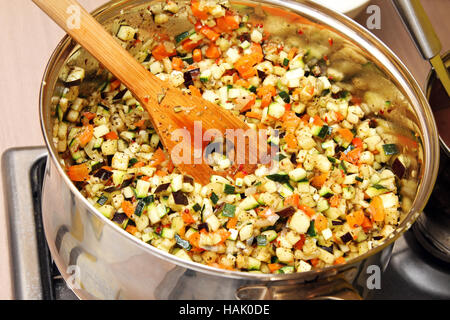 vegetables cooking in a pan on stove Stock Photo