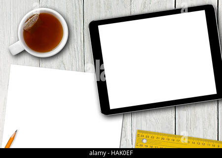 blank digital tablet, tea cup and paper sheet on wooden table Stock Photo
