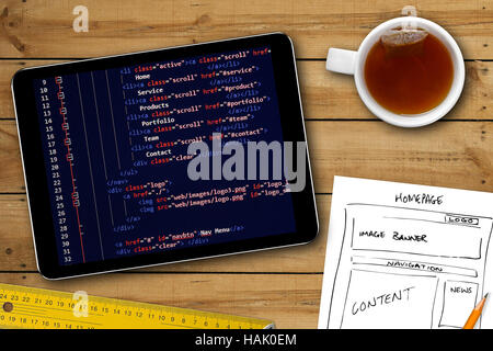 website wireframe sketch and programming code on digital tablet screen Stock Photo