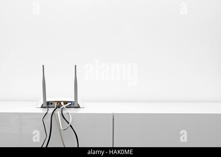 wifi internet router on shelf in white interior Stock Photo