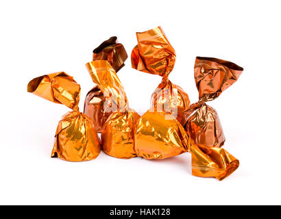 group of chocolate candies wrapped in shiny paper isolated on white Stock Photo