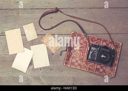 old retro camera on vintage photo album and blank pictures Stock Photo