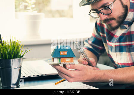 architect, construction engineer taking measurements of new house project at office Stock Photo