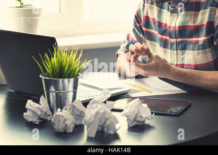 office workplace with many crumpled paper balls on the table Stock Photo