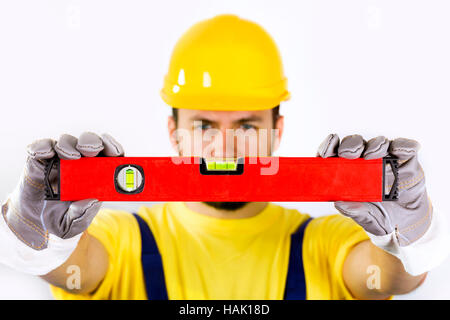 quality control - construction worker with spirit level Stock Photo