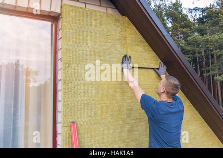 house insulation - insulating house facade with mineral rock wool
