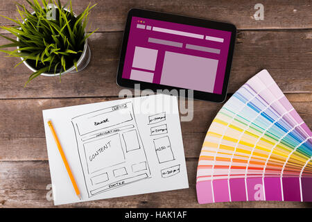 website wireframe sketch and digital tablet on wooden table Stock Photo